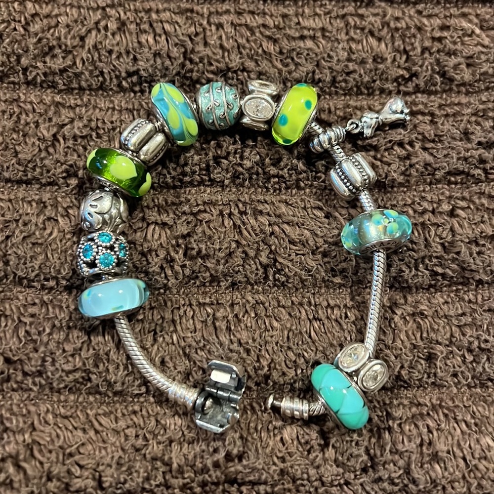 Authentic Pandora bracelet and charms -12 charms and 2 spacers.